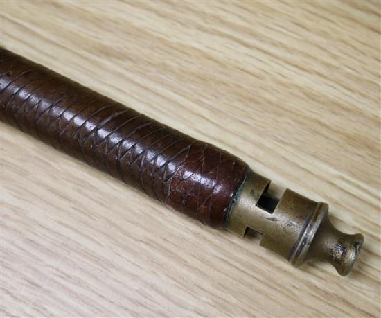 A hunting riding crop with brass whistle
